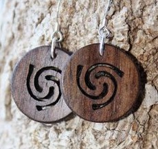 jewelry of palm wood, an ear tag with a carved
              swirl