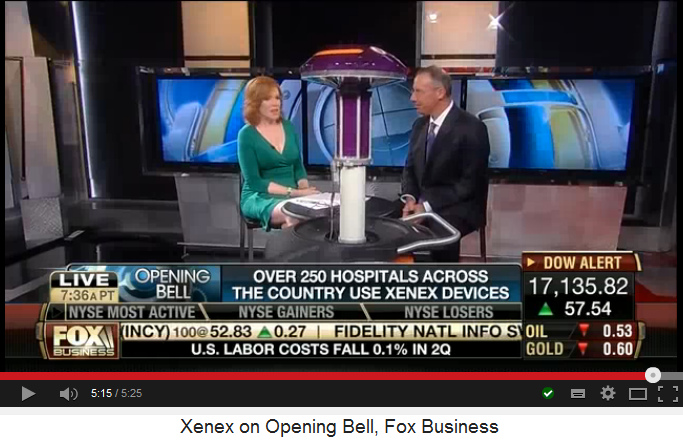 Reporter and CEO
                            Morris Miller with Xenex UV light
                            disinfection robot, final position