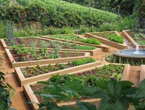 Garden in the form of a mandala garden
                          with raised beds in the form of rhomboids and
                          triangles with a fountain in the middle